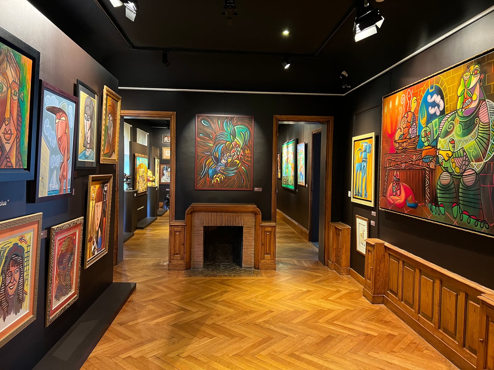 GODON BIO exhibition view: paintings by Alain Godon hung on dark walls in the museum's galleries