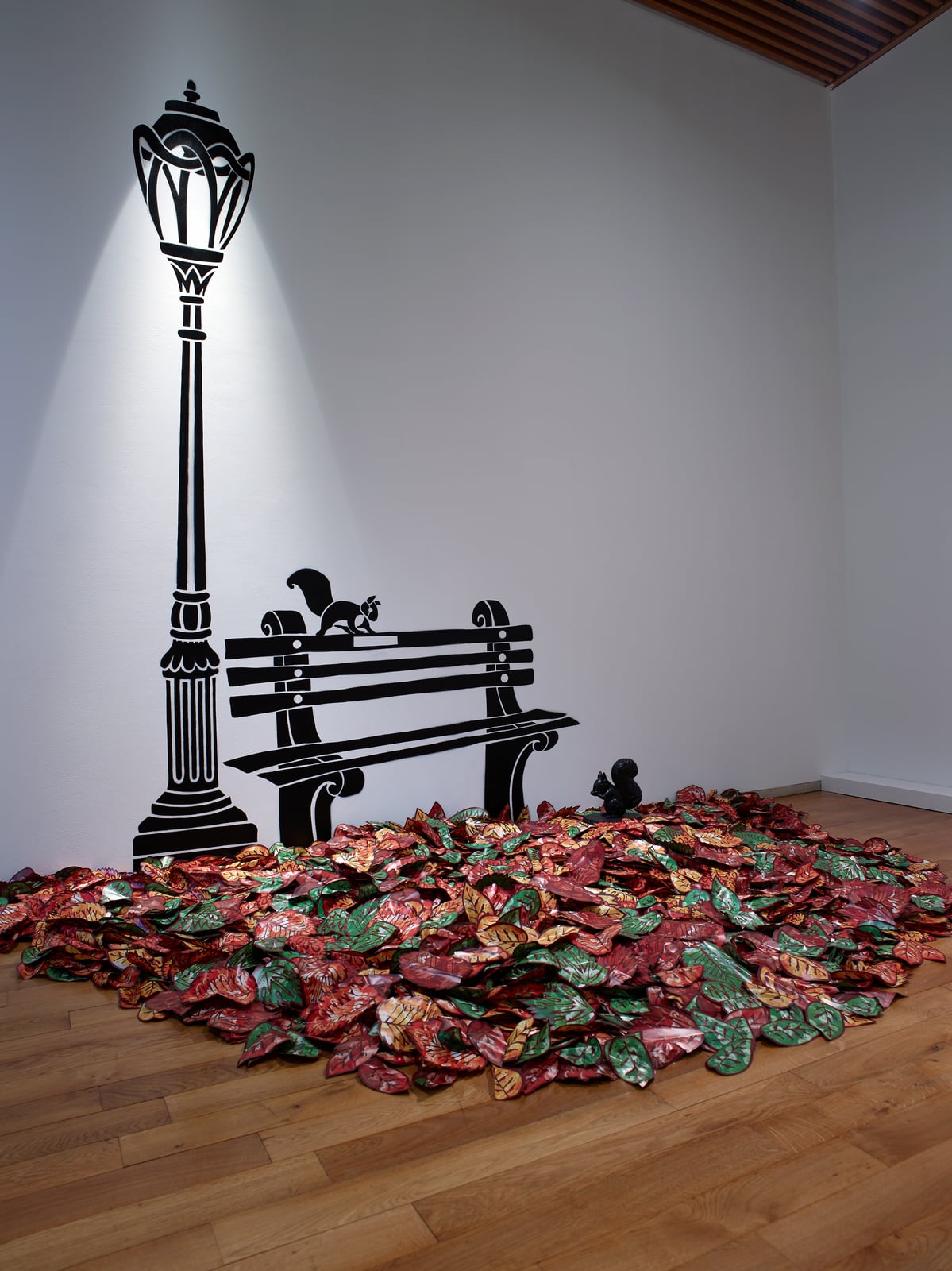 Matisse-Godon exhibition view: Alain Godon's street lamp and bench installation on a bed of painted leaves