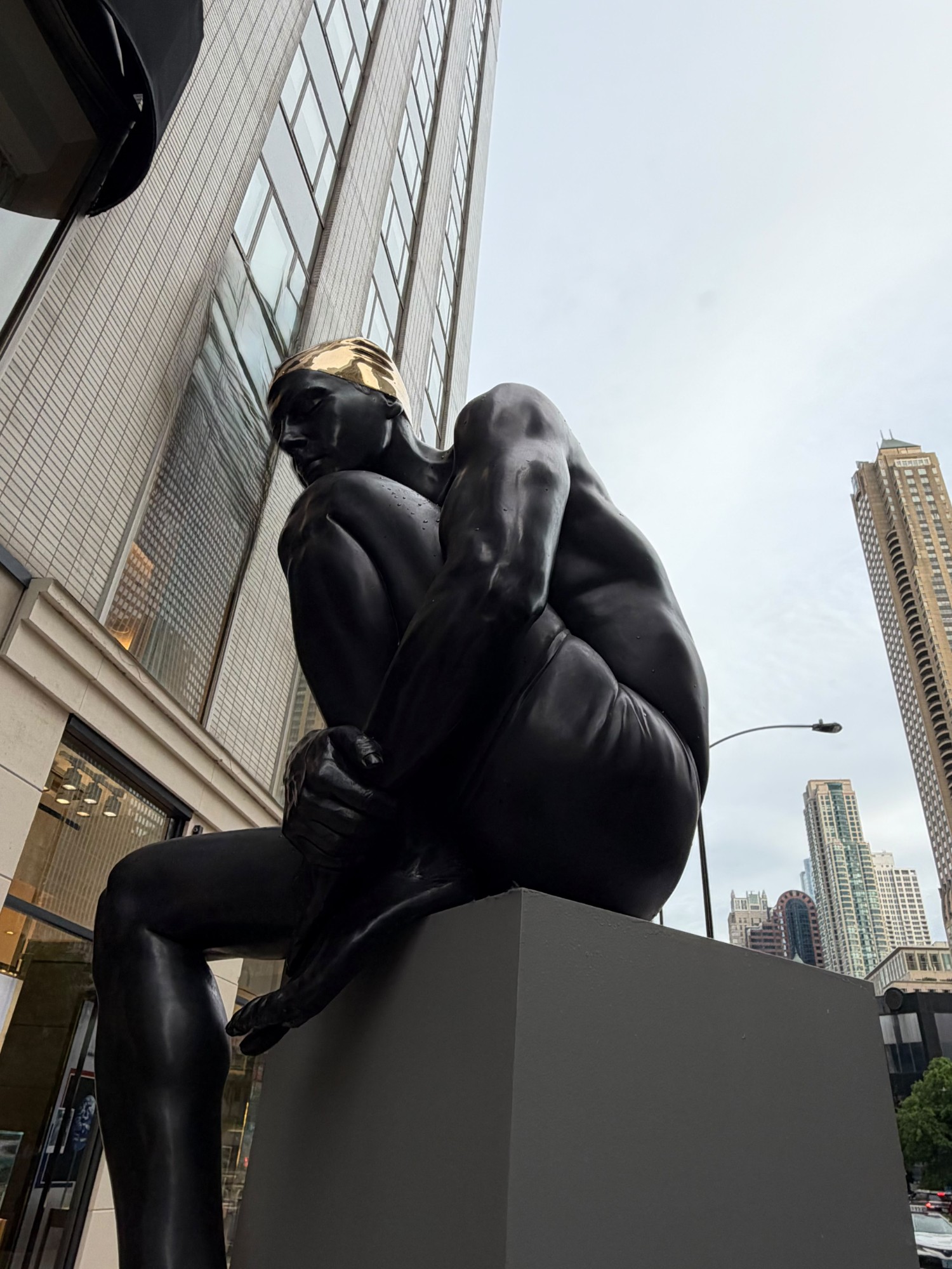Carole A. Feuerman monumental black and gold swimmer sculpture on the Magnificent Mile, Chicago
