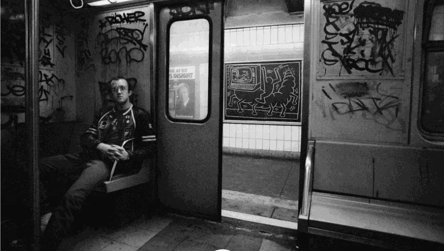 Tseng Kwong Chi, Keith Haring, drawing in the subway, New York, circa 1983. Photo © Muna Tseng Dance Projects, Inc. Art © Keith Haring Foundation