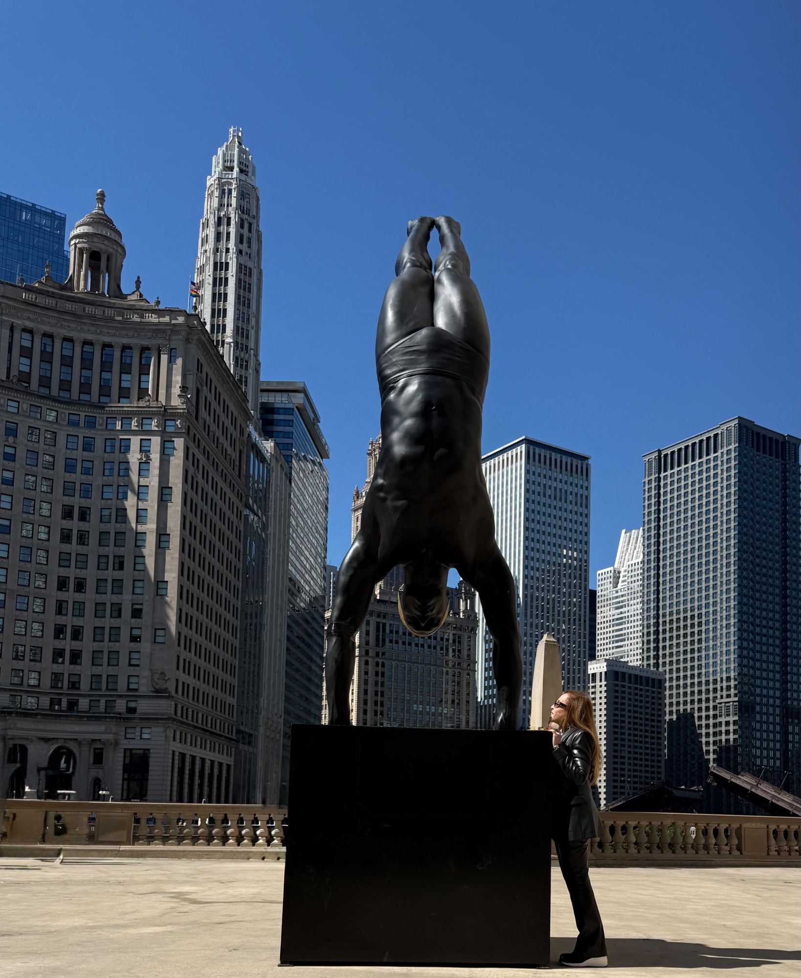 Carole A. Feuerman monumental diver sculpture in a handstand above the Chicago River, Monuments of Stillness
