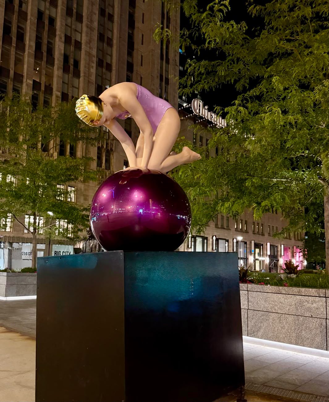 Carole A. Feuerman swimmer on a purple sphere at night, Michigan Avenue, Chicago