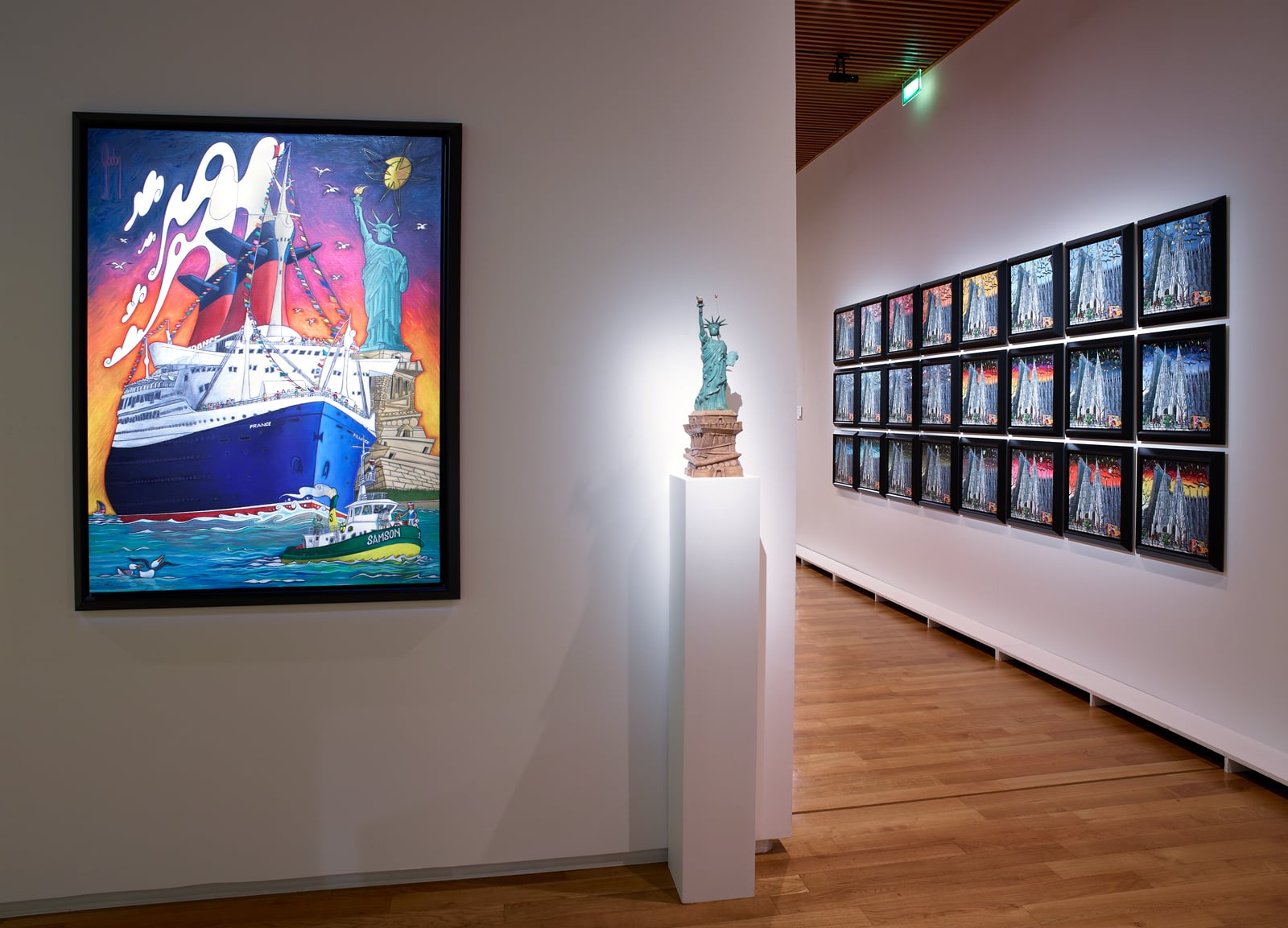 Matisse-Godon exhibition view: an ocean-liner painting by Alain Godon beside a wall of framed prints and a bronze sculpture