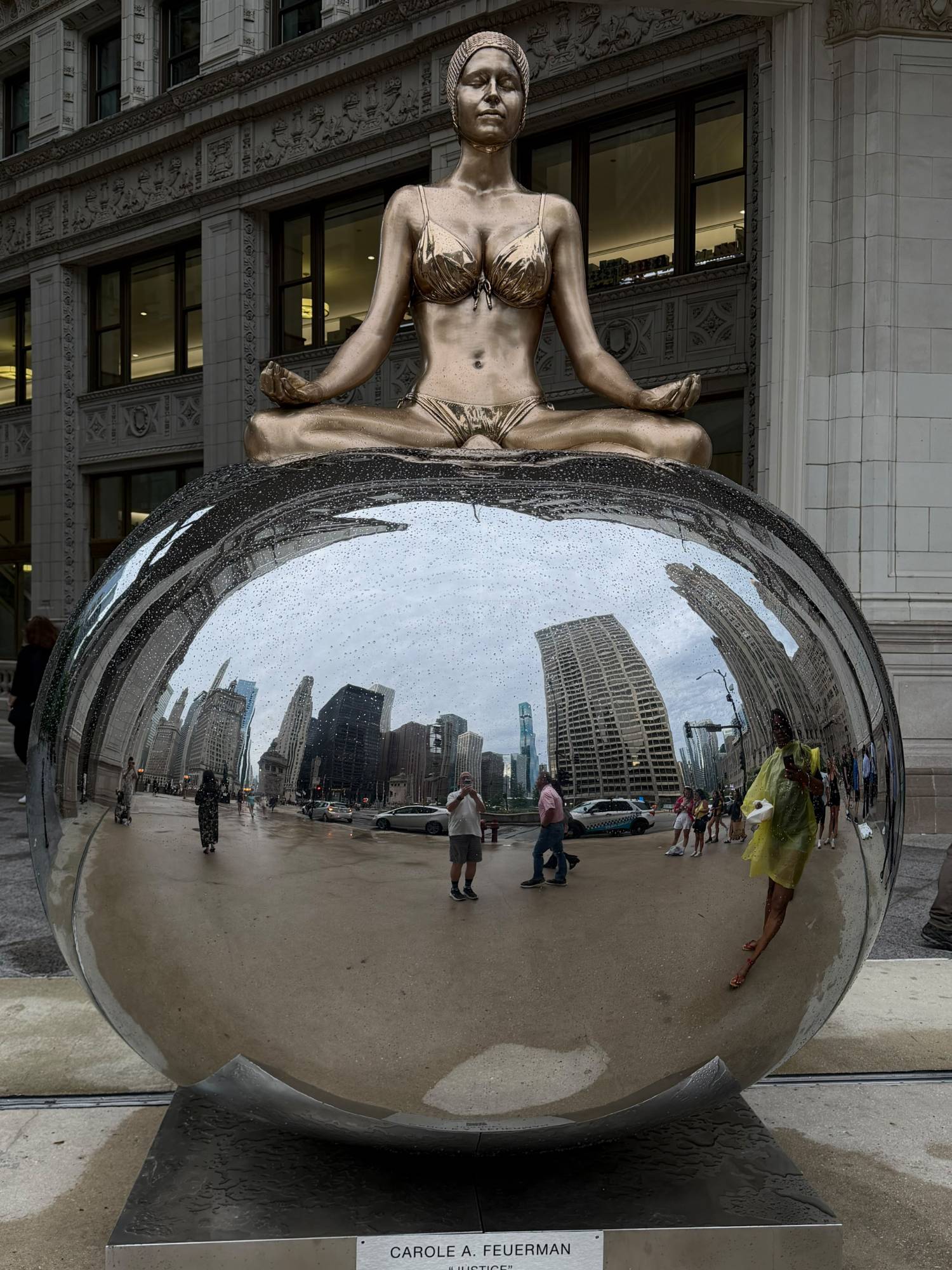 Carole A. Feuerman, Justice, meditating swimmer on a mirrored sphere in front of the Wrigley Building, Chicago